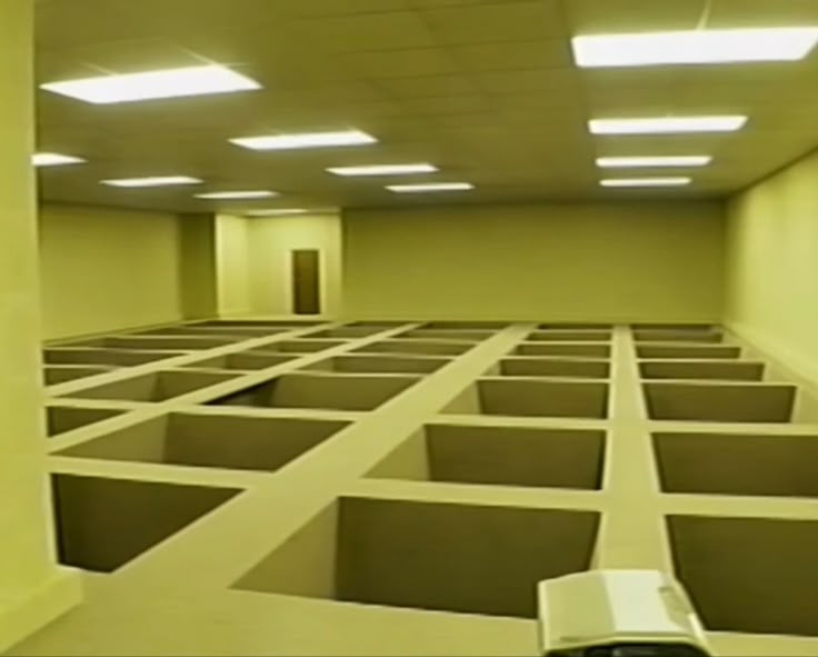 A bizarre Backrooms level with rectangular pits cut into the floor